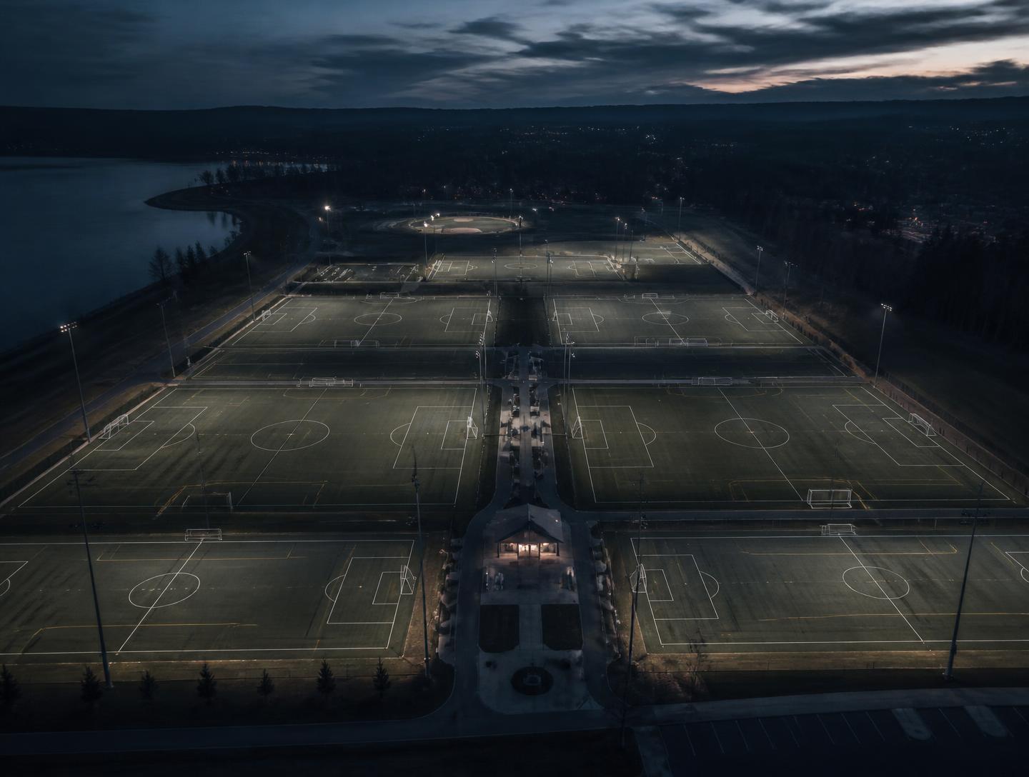 Aerial view of a multi-field youth sports park at dusk